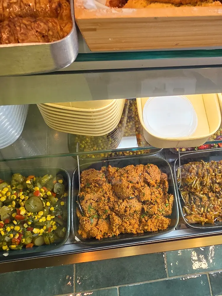 Deli counter trays of kısır, green beans in olive oil, pickled salad and yoghurt dip